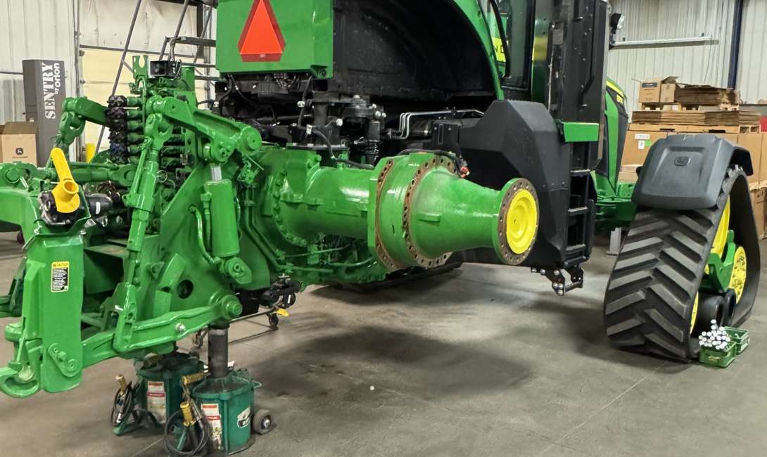 A John Deere tractor being worked on in the manufacturing support section.